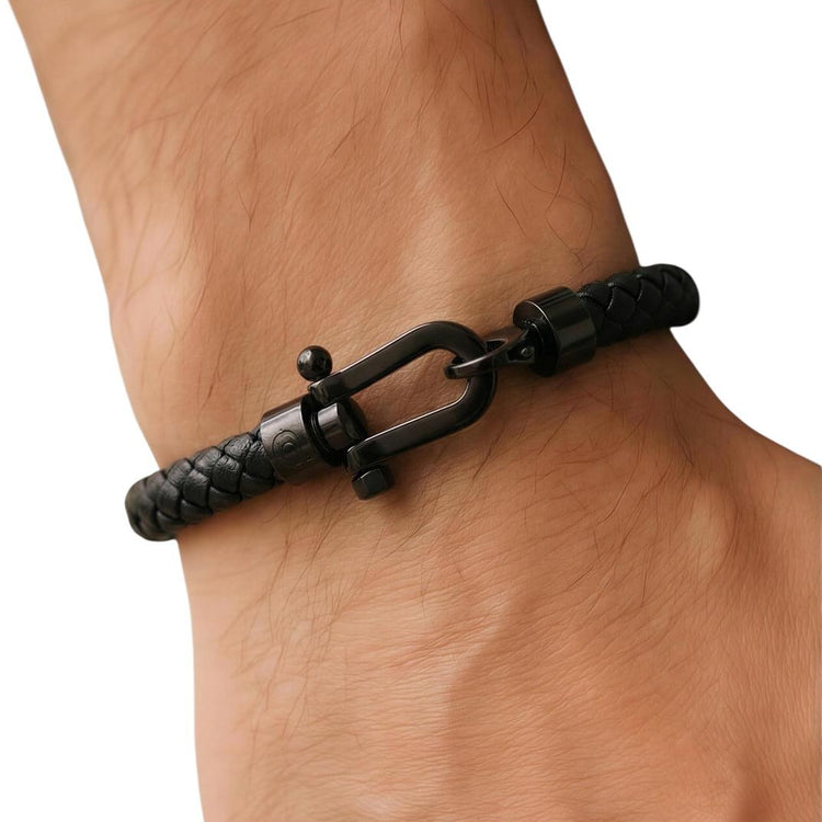 Black bracelet on a wrist against a white background