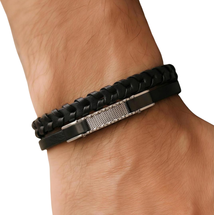 Black braided bracelet on a wrist with a white background