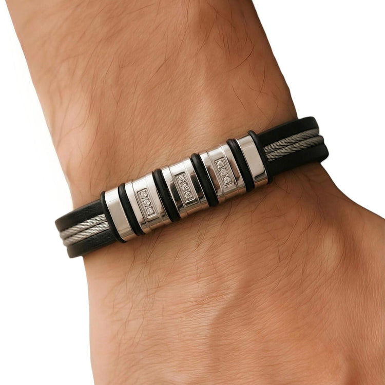 Black leather bracelet with silver accents on a wrist against a white background