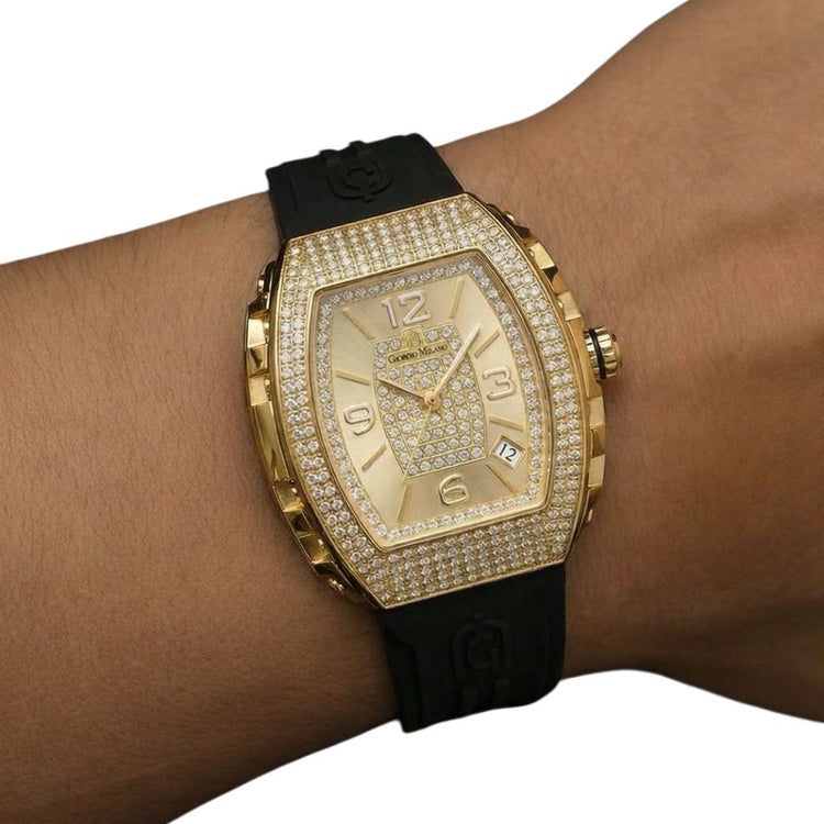 Gold watch with black strap on wrist against a white background