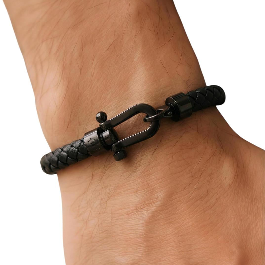 Black bracelet on a wrist against a white background