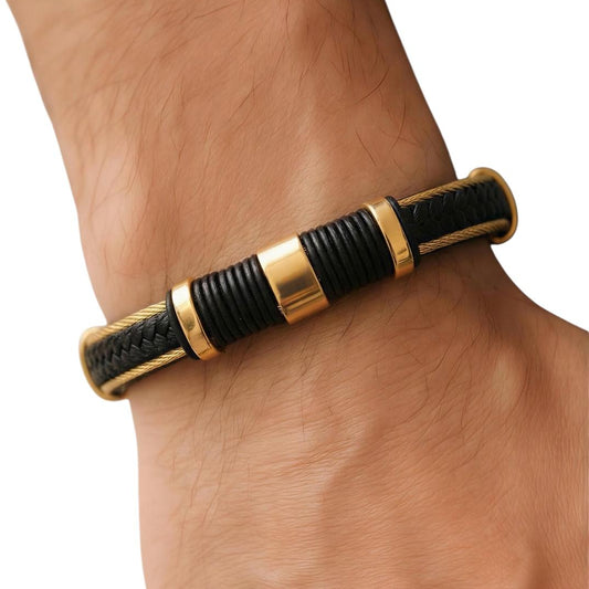 Black and gold bracelet on a wrist against a white background