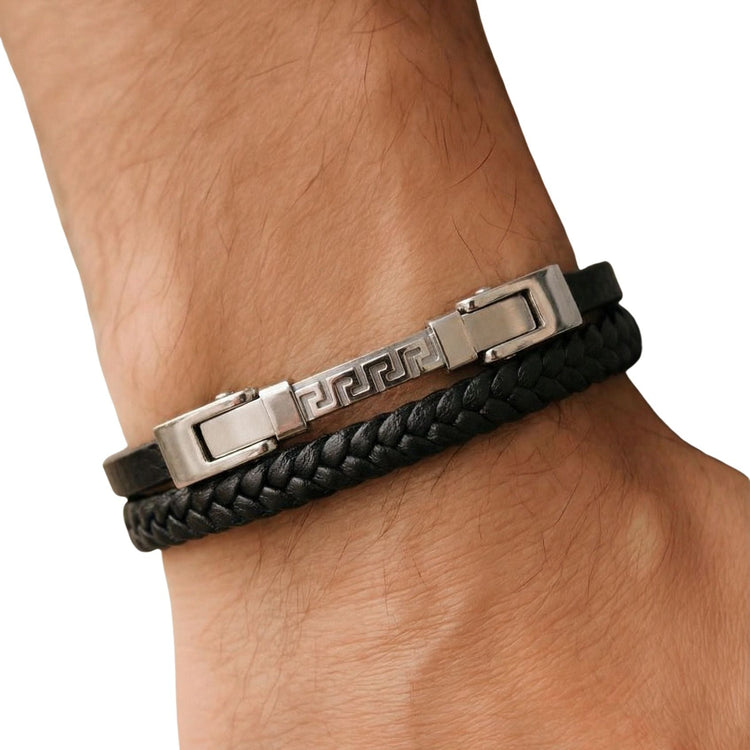 Black braided leather bracelet with metal clasp on a wrist against a white background
