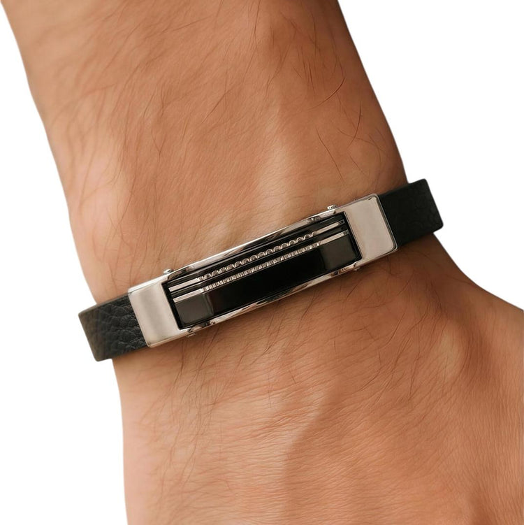 Black and silver bracelet on a wrist with a white background