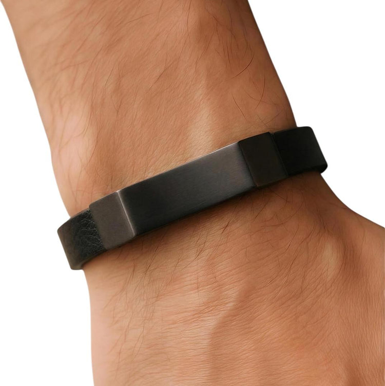 Black fitness tracker on a wrist against a white background