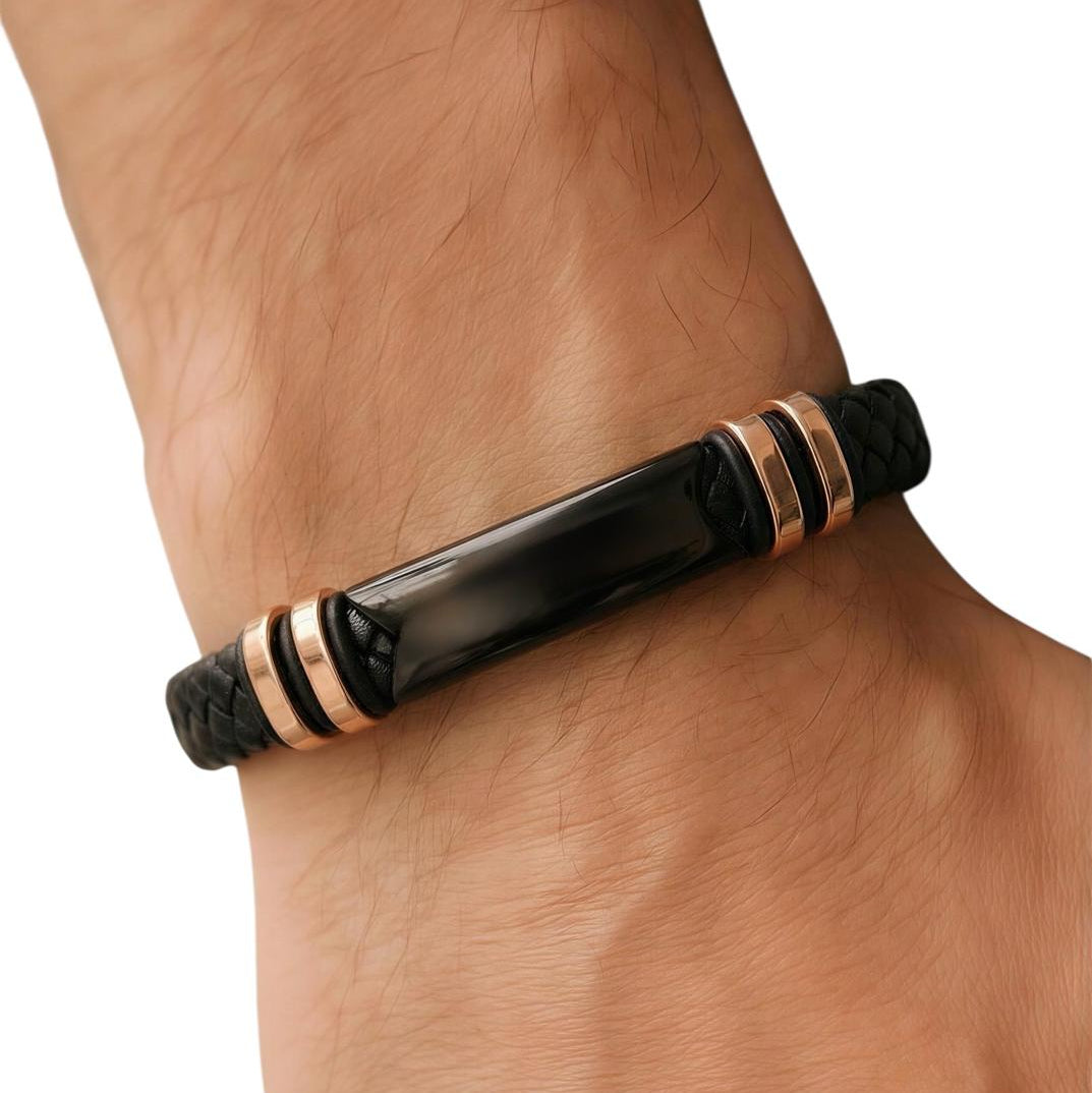 Black and rose gold bracelet on a wrist with a white background