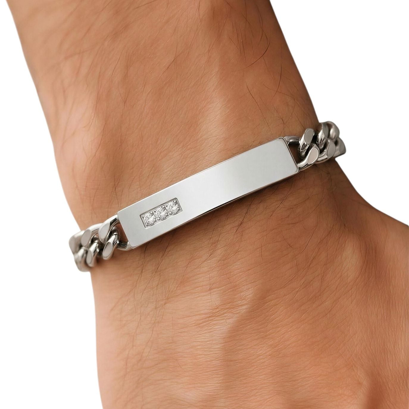 Silver bracelet with a chain design on a wrist against a white background