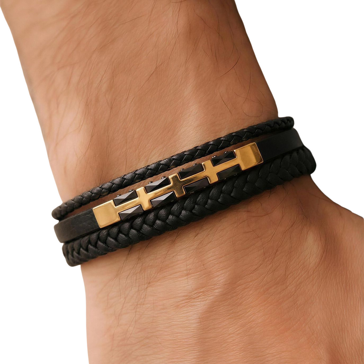 Black braided leather bracelet with gold accents on a wrist against a white background