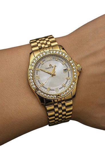 Gold wristwatch with diamond-studded bezel on a wrist against a white background