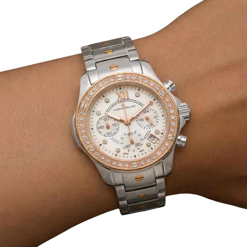 Silver and rose gold watch on a wrist with a white background