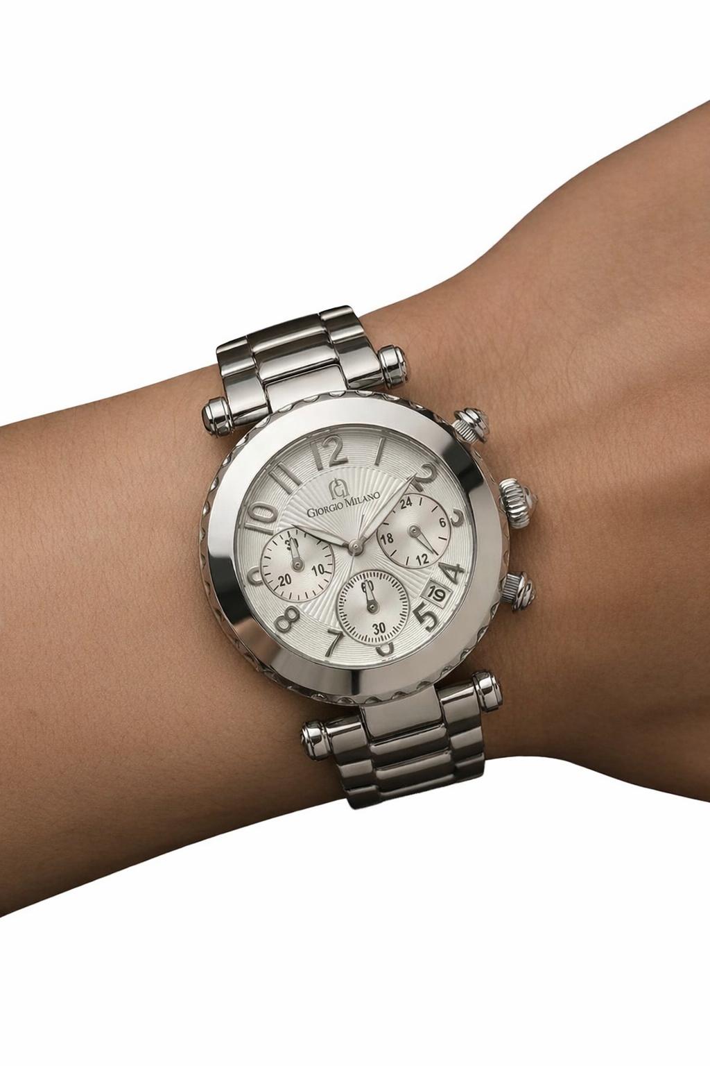 Silver watch on a wrist with a white background