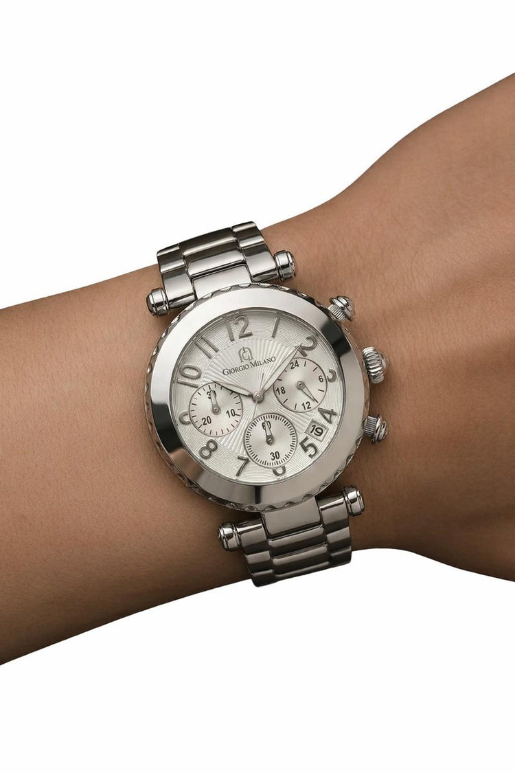 Silver watch on a wrist with a white background