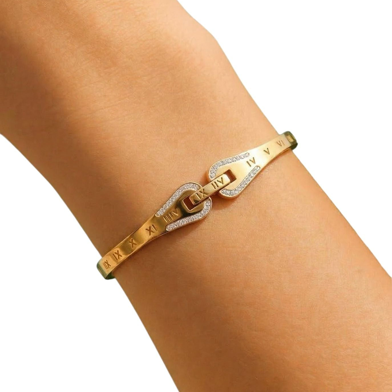 Gold bracelet on a person's wrist with a plain background