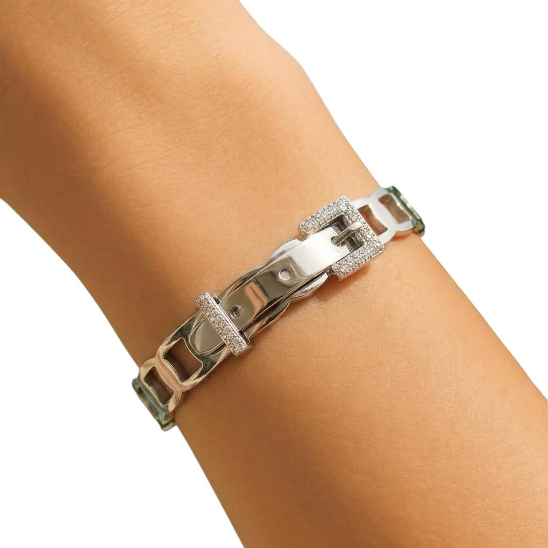 Silver chain bracelet on a wrist with a white background