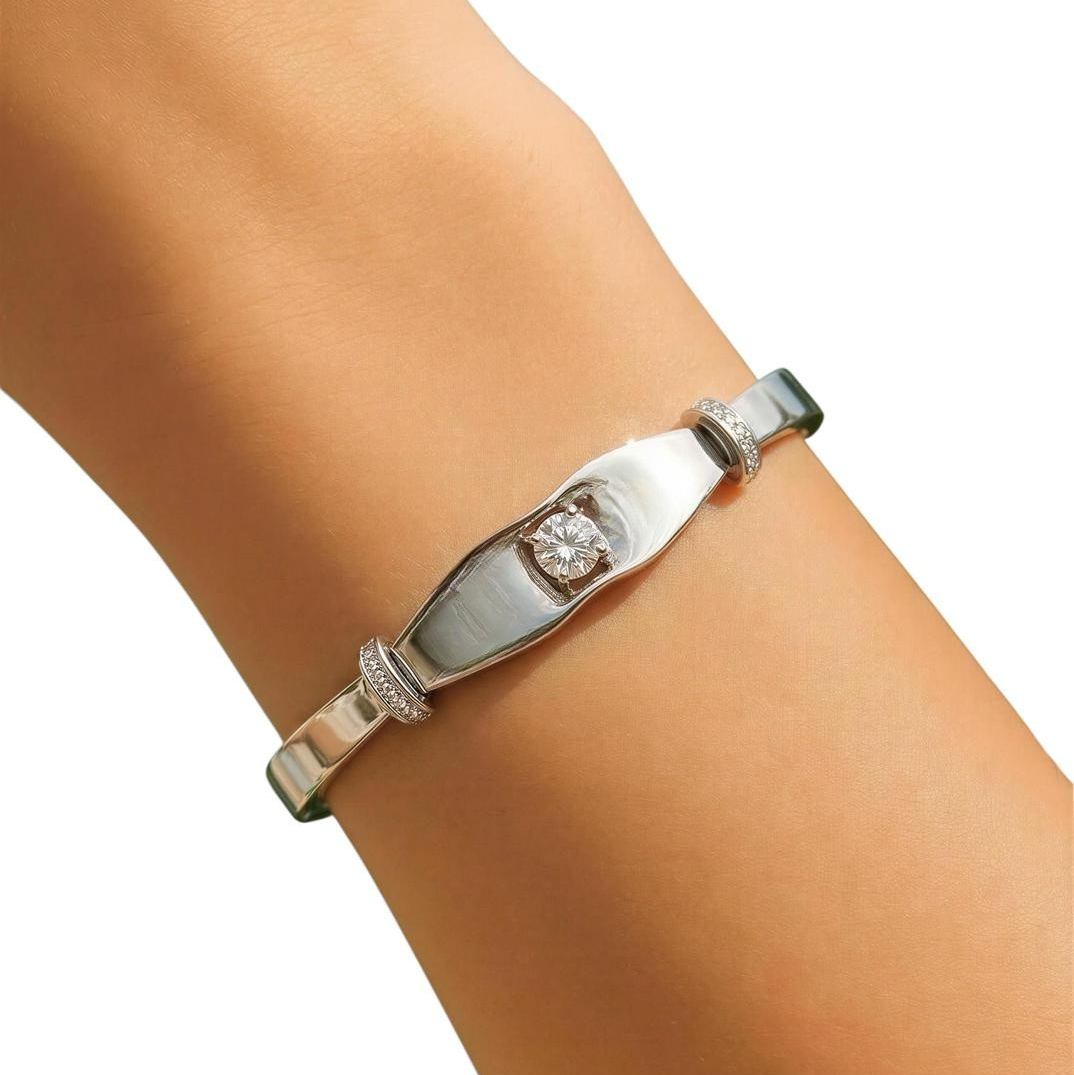 Silver bracelet with a diamond on a wrist against a white background
