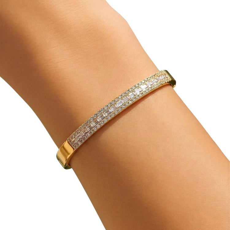 Gold bracelet with diamonds on a wrist against a white background